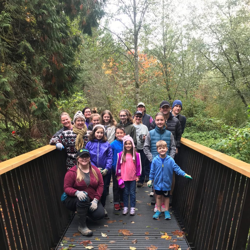 Group of 16 people on a bridge in the forest